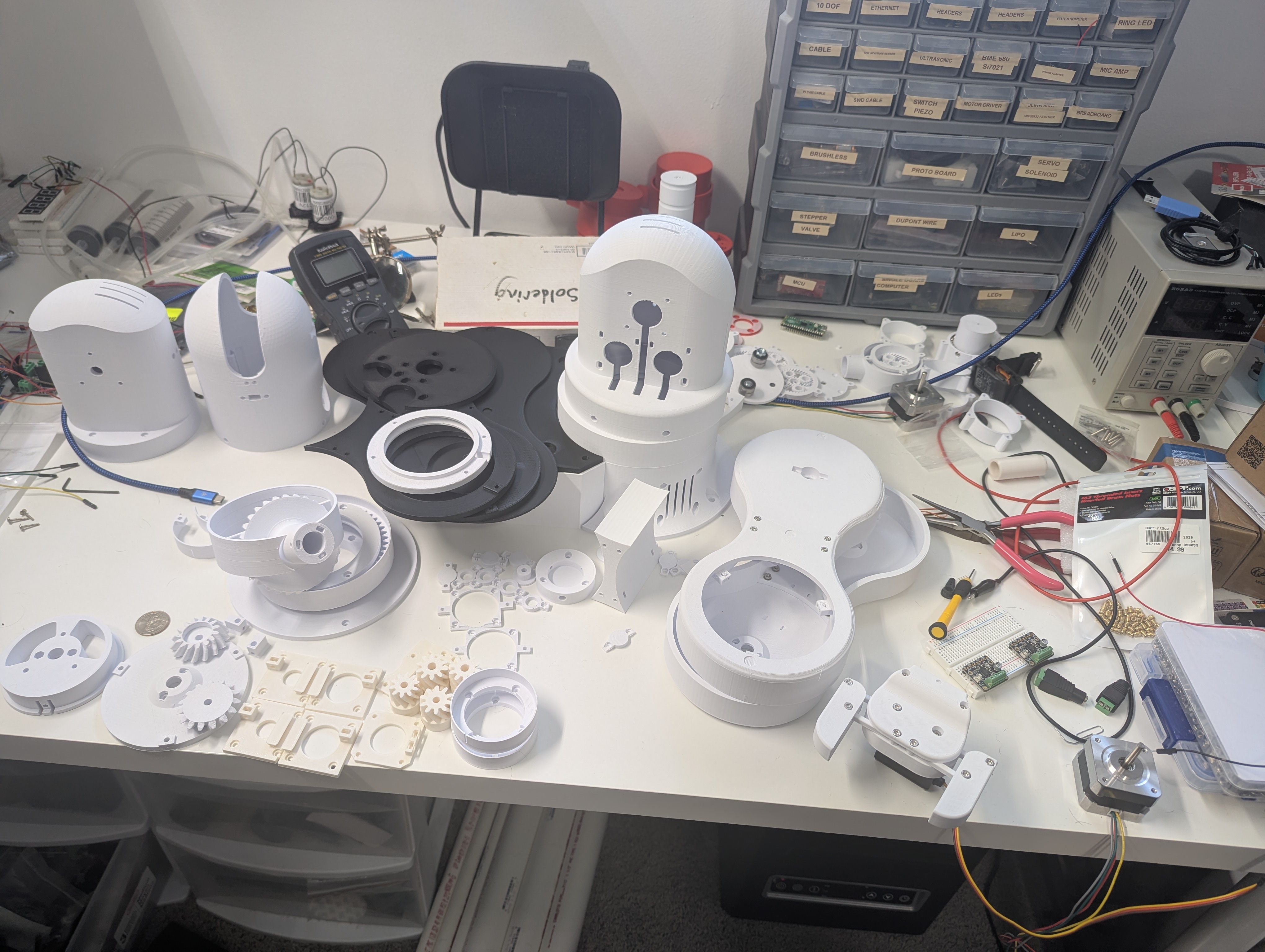 A desk covered in 3D printed Thor arm parts.